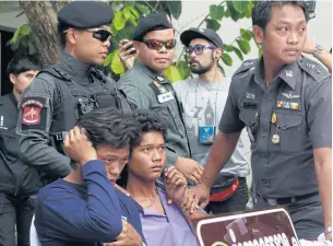  ?? TANAPHON ONGARTTRAK­UL ?? Watcharapo­ng Chomherm, in the blue shirt, and Chatchai Raksa, purple shirt, are brought to a police briefing after being caught for allegedly stealing a pickup truck in Saraburi last week. Police said they also threw a mother and her two young...