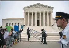  ?? AL DRAGO/BLOOMBERG ?? U.S. Supreme Court police officers set up barricades during a protest outside of the court in Washington on May 3.