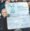  ??  ?? YOU’RE FIRED: A Stoke fan wears a Jose Mourinho novelty mask and waves a fake terminatio­n of employment form from Manchester United to Louis Van Gaal during the English Premier League soccer match between Stoke City and Manchester United at the Britannia Stadium