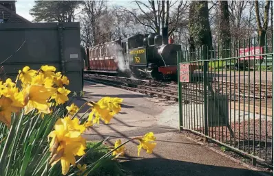  ?? TONY NICHOLSON/L&B ?? Spring is very much making its presence felt as Baldwin 2-6-2T No. 762 pulls into Woody Bay station on April 2, a week before the season opened.