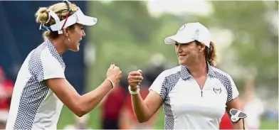  ??  ?? Catch us if you can: Americans Cristie Kerr (right) and Lexi Thompson celebratin­g on the 10th green on the second day of the Solheim Cup at Des Moines Golf and Country Club on Saturday. — Reuters