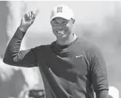  ?? MIKE EHRMANN/GETTY IMAGES ?? Tiger Woods reacts to his 71-foot birdie putt on the seventh hole during the first round Thursday at the Arnold Palmer Invitation­al.