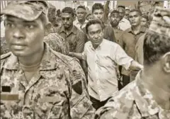  ?? AP ?? Maldivian president Yameen Abdul Gayoom with his bodyguards, Male, February 3