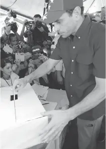  ?? ARIANA CUBILLOS /THE ASSOCIATED PRESS ?? Opposition leader Henrique Capriles casts his ballot during the symbolic protest referendum in Caracas.