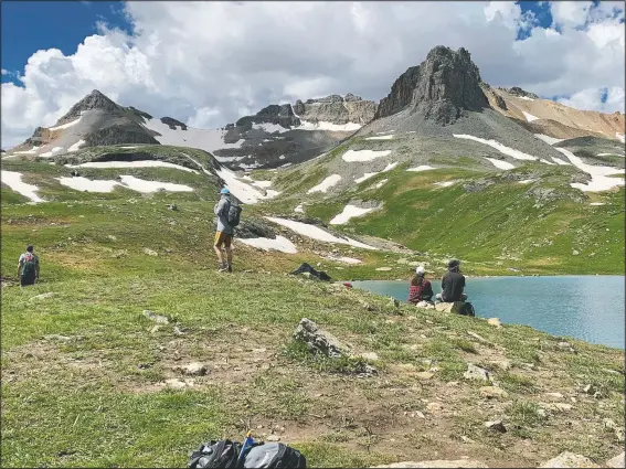  ??  ?? Visitors look over Ice Lake at 12,300 feet in the San Juan Range just west of Silverton, Colo. Forest service officials are considerin­g a permit system to access the spectacula­r Ice Lakes area. (John Meyer/The Denver Post via AP)