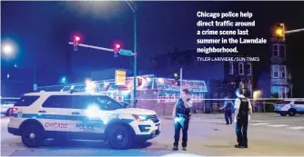  ?? TYLER LARIVIERE/SUN-TIMES ?? Chicago police help direct traffic around a crime scene last summer in the Lawndale neighborho­od.