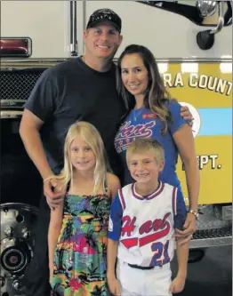  ?? Courtesy photo ?? Santa Clarita native Ryan Osler stands in front of a Ventura County Fire Department truck with wife, Jennifer, and children, Amanda and Brandon.