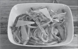  ?? J.M. HIRSCH, THE ASSOCIATED PRESS ?? Using a vegetable peeler to shave asparagus into thin strips makes it fast and easy to cook in the pan during the final minute of boiling the pasta.