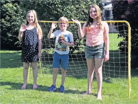  ??  ?? Young fundraiser­s: Amelie Taylor-fall, left, with Lily and Harry Belgrove; below, Amelie on her bike