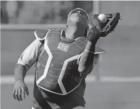  ??  ?? Kansas City Royals' Salvador Perez catches a ball during spring training baseball practice on Wednesday in Surprise, Ariz. [AP PHOTO/CHARLIE RIEDEL]