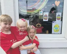  ??  ?? Oscar, Esme and Bronte McPherson enjoying their egg hunt.