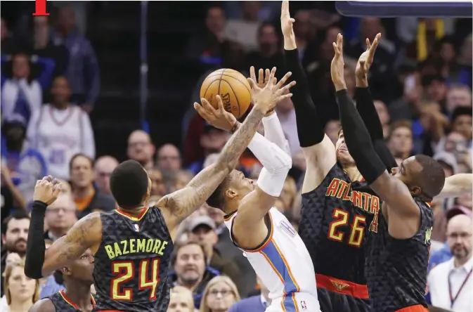  ??  ?? OKLAHOMA CITY: Oklahoma City Thunder guard Russell Westbrook, center, shoots between, from left, Atlanta Hawks guard Dennis Schroder, forward Kent Bazemore (24), guard Kyle Korver (26) and forward Paul Millsap in the fourth quarter of an NBA basketball...