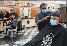 ?? DANA JENSEN/THE DAY ?? Owner Joshua McArthur gives Joshua Bressette of Ledyard a haircut Tuesday in his new shop, The Cave Barbershop, located in the Groton Shopping Plaza. In the background, barber Diovanni Bank gives Jacob Cordero of Groton a haircut.