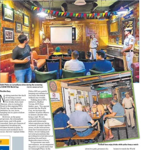  ?? PHOTOS: SARANG GUPTA/HT ?? Delhi Police on surveillan­ce drive during the screening of 2018 FIFA World Cup Football fans enjoy drinks while police keep a watch