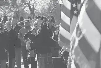  ?? MICHAEL MCANDREWS/HARTFORD COURANT ?? Bagpiper Pat Whelan plays “Amazing Grace” as New Britain marked Veterans Day at Walnut Hill Park on Sunday.