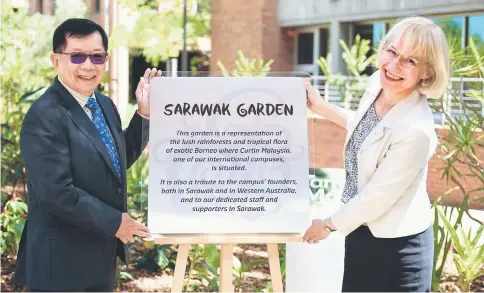  ??  ?? Dr Chan and Terry stand beside the plaque that explains the Sarawak Garden at Curtin University campus in Perth.