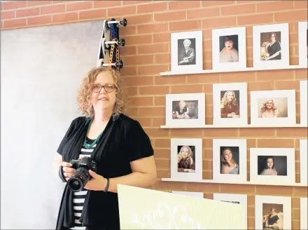  ?? ROB EARNSHAW/DAILY SOUTHTOWN ?? Photograph­er Leann Buss stands inside her studio at St. Paul Community Church. The church in Homewood recently turned part of its building into artist studios after hearing there was a need for studio space in the area.