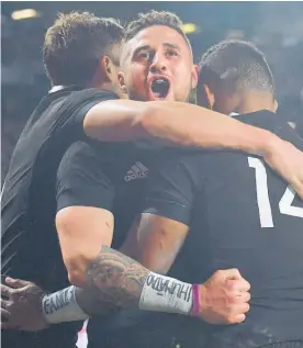  ?? Photo / Photosport ?? TJ Perenara’s protest wristband is obvious as he celebrates Sevu Reece's try during the All Blacks vs Australia match at Eden Park.