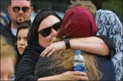  ?? SCOTT OLSON / GETTY ?? Host-family members of Sabika Sheikh are comforted after a funeral service in Stafford on May 20. Sheikh, a Pakistani exchange student, was killed last Friday in a mass shooting at Santa Fe High School.