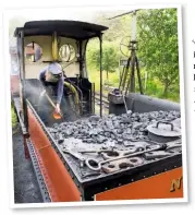  ?? ALAMY ?? One should avoid firing a ‘Quarry Hunslet’ on the move. Kay Bowman shovels coal from Works No. 679 Covertcoat ’s tender – fitted in 1991 to increase coal and water capacity – at Launceston.