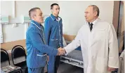  ?? ?? Vladimir Putin visits soldiers wounded in the Ukraine conflict at the Mandryk Military Clinical Hospital in Moscow. He reportedly did not ask the men about their experience on the battlefiel­d
