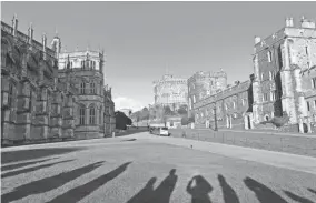  ?? MICHELLE LOCKE VIA AP ?? The shadows of visitors can be seen lining up to hear evensong at St. George’s Chapel at Windsor Castle in Windsor, England, in March. If you’re visiting London on a budget, a six-day London pass covers admission to a number of attraction­s and comes...