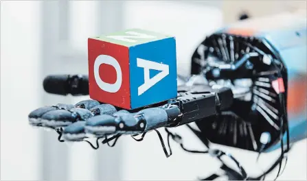  ?? ERIC LOUIS HAINES OPENAI VIA THE ASSOCIATED PRESS ?? A robotic hand, called Dactyl, at OpenAI’s research lab in San Francisco. Its job is to rotate a cube until the top letter matches a random selection.