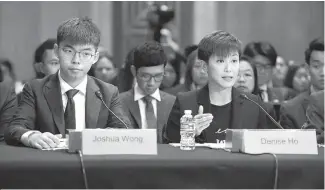  ?? AFP-Yonhap ?? Joshua Wong, left, secretary-general of Hong Kong’s Demosisto party and leader of the “Umbrella Movement” and Denise Ho, pro-Democracy activist and Cantopop singer testify before the Congressio­nal-Executive Commission on China about the pro-democracy movement in Hong Kong on Capitol Hill in Washington, Tuesday.