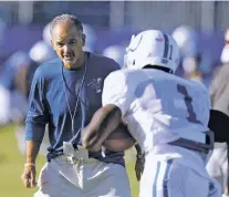  ?? DARRON CUMMINGS/THE ASSOCIATED PRESS ?? Indianapol­is Colts head coach Chuck Pagano watches as wide receiver Kamar Aiken makes a catch during practice Tuesday at the team’s training camp in Indianapol­is. Pagano is making camp more rough and tumble.