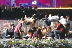  ??  ?? Audience members at the Route 91 Harvest country festival in Las Vegas flee a hail of bullets from gunman Stephen Paddock