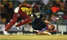  ?? Photograph: Gareth Copley/Getty Images ?? Reece Topley runs out West Indies’ Shai Hope with a stunning piece of fielding in his follow through almost six years after his last England T20I.