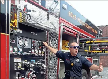  ?? / Diane Wagner ?? Sgt. Alex Routt of the Rome-Floyd County Fire Department points Monday to the air horn button on the newly delivered heavy rescue pump truck he will be driving.