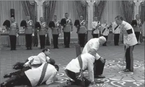  ??  ?? Thai prime minister Prayuth Chan-Ocha (centre), privy council president General Prem Tinsulanon­da (seated) and others prostrate themselves in front of newly appointed King Maha Vajiralong­korn. (Photo: Getty Images)