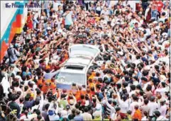  ?? HENG CHIVOAN ?? Mourners surround a vehicle carrying the body of slain political commentato­r Kem Ley during his funeral in July last year.