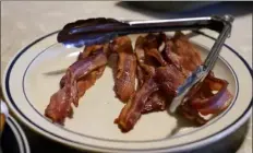  ?? ?? A plate of bacon sits on the kitchen table on the ron Mardesen farm near elliott, Iowa,