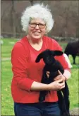  ?? Christian Abraham / Hearst Connecticu­t Media ?? Carol Sepe poses with a baby lamb at Sepe Farm in Newtown.