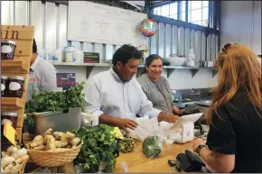  ?? CRYSTAL PAUL/SEATTLE TIMES ?? Santos and Zenaida Guadarrama are the first and only Latino business owners operating out of Pybus Market. Their market Royal Produce is mostly supplied from their family-owned farm in Royal City, Wash.