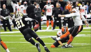  ?? Bill Feig ?? The Associated Press Browns kicker Zane Gonzalez misses an extra point as Saints defensive back Patrick Robinson defends in the second half of a 21-18 Cleveland loss in New Orleans.