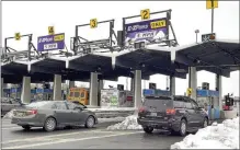  ?? FILE PHOTO ?? Eastbound traffic flows at the New York State Thruway Exit 24 toll barrier in Guilderlan­d, N.Y..