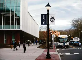  ?? Tyler Sizemore / Hearst Connecticu­t Media ?? Students walk to class at the UConn campus in Storrs. In 1982, a group of academics that called themselves the Yiddish tish began gathering to read and interpret Yiddish classical literature.