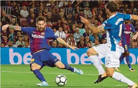  ?? REUTERS PIC ?? Barcelona’s Lionel Messi scores their first goal against Espanyol in the La Liga at Nou Camp on Saturday.