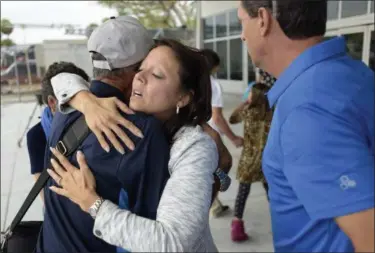  ?? MICHAEL LAUGHLIN — SOUTH FLORIDA SUN-SENTINEL VIA AP ?? Enid Acosta hugs her father Hector Acosta after he arrived at Fort Lauderdale/Hollywood Internatio­nal Airport, Friday on an IBC Airways flight that evacuated seniors from Puerto Rico. The flight was provided by a local nonprofit organizati­on, the...