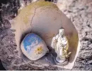  ??  ?? AT TOP: A rock with a faded image of El Santuario de Chimayó rests in a niche along a main road in the town.