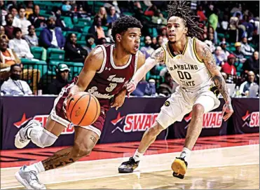  ?? BUTCH DILL / AP ?? Texas Southern guard PJ Henry (3) drives to the basket around Grambling State guard Virshon Cotton (00) during the second half of an NCAA college basketball game in the championsh­ip of the Southweste­rn Athletic Conference tournament on Saturday in Birmingham, Ala.