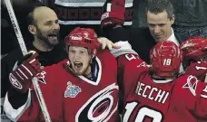  ?? LARRY WONG ?? The Carolina Hurricanes bench erupts in jubilation after they defeated the Edmonton Oilers in Game 7 of the NHL Stanley Cup Final in 2006. The team’s trainer, Peter Friesen, has Saskatchew­an roots.