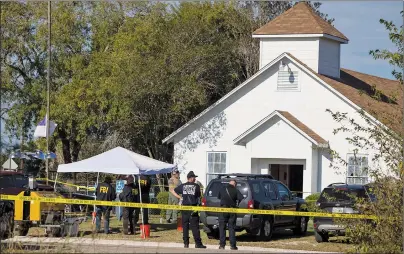  ?? AP PHOTO ?? Law enforcemen­t officials works at the scene of a fatal shooting at the First Baptist Church in Sutherland Springs, Texas, on Sunday.
