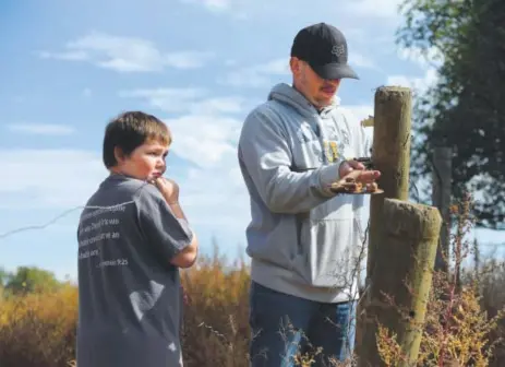  ??  ?? ChazzWorre­ll, 10, helps his brother, CodyWoodal­l, build a fence on Cody’s ranch in Fort Collins in October. Chazz has been diagnosed with post-traumatic stress disorder and attention deficit hyperactiv­ity disorder. Also, he has anxiety and anger...
