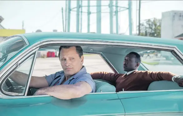  ?? UNIVERSAL PICTURES ?? Actors Viggo Mortensen, left, and Mahershala Ali star as an odd couple on a tour of the Jim Crow Deep South in the Oscar-touted Green Book.