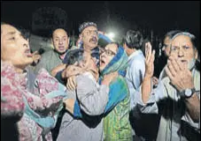  ?? AP PHOTO ?? Relatives and friends of Bukhari react in shock .