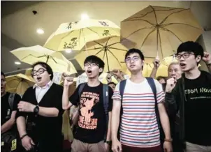  ?? PHILIPPE LOPEZ/AFP ?? Student protesters Joshua Wong (centre left) has said he does not support any of the candidates for the election and will attend a protest outside a voting venue.
